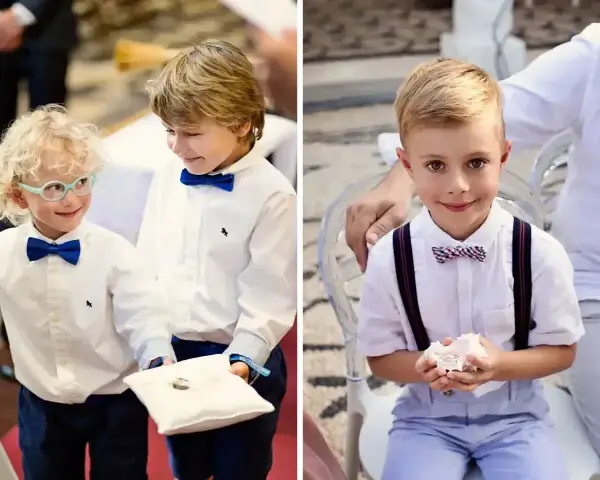 Dwóch chłopców w eleganckich strojach niesie obrączki na poduszce. Jeden z nich ma okulary.